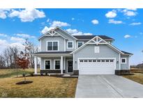 Charming two-story home featuring a two-car garage, covered porch, and gray siding with white trim at 4103 Railhead Ave, Westfield, IN 46074