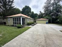 Charming ranch home with a copper roof, screened porch, and detached garage at 5140 Sunny Meade Ln, Indianapolis, IN 46208