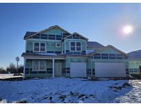 New construction home exterior; white siding, white garage door, and snow covered yard at 6039 Granby Dr, Whitestown, IN 46075