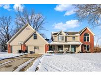 Two-story house with attached garage, covered porch, and a basketball hoop in the driveway at 7136 Hidden Valley Dr, Plainfield, IN 46168