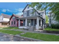 Charming two-story home with a covered front porch and well-maintained lawn at 730 Sanders St, Indianapolis, IN 46203