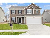 Charming two-story home featuring a spacious two car garage and beautiful lawn at 10115 Redwood Peak Ln, Indianapolis, IN 46259