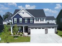 Two-story home with gray and blue exterior, three-car garage, and landscaped yard at 19243 Foley Dr, Westfield, IN 46074
