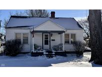White house with covered porch, snow on ground at 2425 17Th St, Columbus, IN 47201