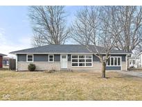 Newly renovated ranch home with gray and beige exterior and landscaped lawn at 2521 Cicero Rd, Noblesville, IN 46060