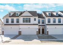 Three-unit townhome building with white siding, gray roofs, and attached garages at 3298 Morab Dr, Zionsville, IN 46077