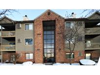 Brick and siding condo building with snow-covered landscaping at 4351 Village Parkway W Cir # 5, Indianapolis, IN 46254