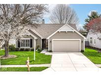 Charming single-story home with a large garage and well-manicured lawn at 4842 Ashbrook Dr, Noblesville, IN 46062