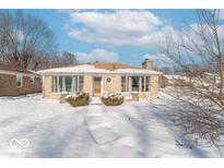 Ranch style home with snow covered lawn at 502 W 38Th St, Indianapolis, IN 46208