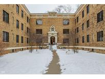 Brick apartment building courtyard with a snow covered walkway at 5347 N College Ave # 308, Indianapolis, IN 46220