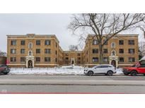 Brick apartment building with snow covered landscaping at 5347 N College Ave # 308, Indianapolis, IN 46220