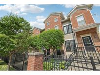 Two-story brick townhomes with wrought iron fences at 6595 Reserve Dr, Indianapolis, IN 46220