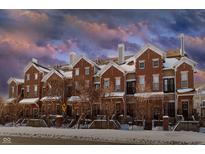 Beautiful brick townhomes with snow-covered roofs and charming front yard fences creating an inviting curb appeal at 6595 Reserve Dr, Indianapolis, IN 46220
