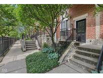 Charming brick townhomes with landscaped front entrances and black iron railings add to this inviting exterior at 6595 Reserve Dr, Indianapolis, IN 46220
