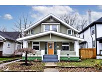 Charming two-story house with a green exterior, white trim, and a welcoming front porch at 926 N Dearborn St, Indianapolis, IN 46201