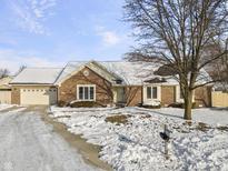 Brick ranch home with attached garage and snow-covered yard at 10 Sycamore Ct, Brownsburg, IN 46112