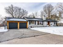 Stunning ranch home with a newly renovated exterior, featuring a modern two-car garage at 101 E 96Th St, Indianapolis, IN 46240