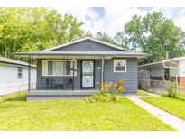 Charming home featuring a covered front porch and a well-manicured lawn, perfect for curb appeal at 1704 Nelson Ave, Indianapolis, IN 46203