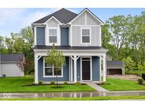 Charming two-story home with a covered front porch and well-manicured lawn at 1705 Real St, Indianapolis, IN 46240