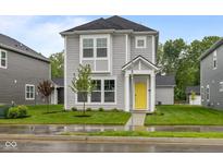 Charming two-story home with a bright yellow front door and well-manicured lawn at 1709 Real St, Indianapolis, IN 46240