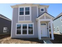 Charming two-story home with gray siding, white trim, and a welcoming front entrance at 1709 Real St, Indianapolis, IN 46240