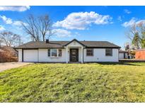 Charming ranch home with white brick exterior and landscaped lawn at 1904 Schwier Dr, Indianapolis, IN 46229