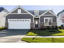 Charming home featuring a two-car garage, stone accents, and a well-manicured lawn at 19629 Astoria Ave, Sheridan, IN 46069