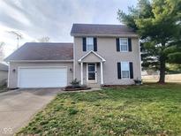 Two-story house with attached garage and landscaped lawn at 2062 Sumpter Trl, Columbus, IN 47203