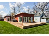 Expansive backyard featuring a large wooden deck with a hot tub and stylish outdoor seating at 2894 W Grove Dr, Greenfield, IN 46140