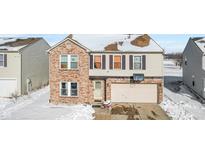 Two-story brick home with attached garage and basketball hoop at 300 Winterset Way, Greenwood, IN 46143