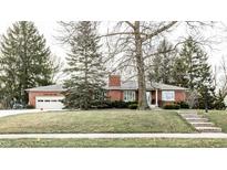 Brick Ranch home with attached garage, landscaping, and a large tree in the front yard at 441 W Main St, Carmel, IN 46032