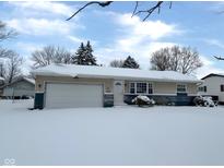 Snow covered ranch home with attached garage and landscaping at 529 S Kiel Ave, Indianapolis, IN 46241