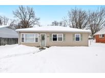 Tan house with snow covered yard at 555 N Sadlier Dr, Indianapolis, IN 46219