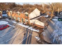 Brick townhouse with attached garage and parking at 5619 N Rural St, Indianapolis, IN 46220