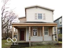 Two-story house with front porch and wood siding at 815 W 28Th St, Indianapolis, IN 46208
