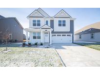 Two-story home with gray siding, white accents, and a two-car garage at 8870 Walker St, Fortville, IN 46040