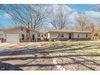 Charming single-story home with an attached garage and well-maintained front yard on a sunny day at 9400 N Bishop Ln, Mooresville, IN 46158