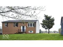 Charming two-story brick home with a well-maintained lawn and inviting front entrance at 9812 W 900 N Rd, Elwood, IN 46036