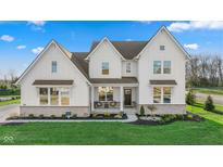 Stunning two-story home with white siding, covered front porch, professionally landscaped yard, and brick accents at 11430 Aubrey Ln, Fishers, IN 46040