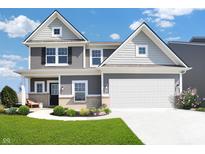 Charming two-story home with gray siding, brick accents, and a well-manicured lawn at 11614 Hartwell St, Indianapolis, IN 46235