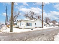 Cozy bungalow with a snow-covered yard at 1363 & 1367 S Belmont Ave, Indianapolis, IN 46221