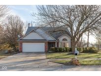 Brick ranch house with attached garage and mature trees at 14807 Beacon Blvd, Carmel, IN 46032