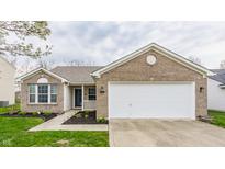 Charming single Gathering home with brick and siding, attached garage and freshly mulched landscaping at 1681 Copeland Farms Dr, Greenfield, IN 46140