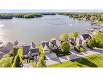Stunning aerial view of waterfront homes, showcasing lake access and beautiful landscaping at 3150 Beach Blvd, Cicero, IN 46034