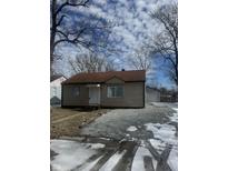 Charming single-story home with gravel yard and detached garage offers a cozy and inviting curb appeal at 3355 Wallace Ave, Indianapolis, IN 46218