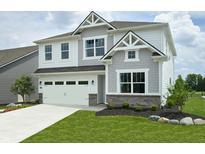 Charming two-story home with a manicured lawn, attached two-car garage and beautiful gray and white color scheme at 5107 Maddox Ln, Whitestown, IN 46075