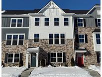 Two-story townhome with stone and gray siding, and a red front door at 6322 Loraine Dr, Brownsburg, IN 46112