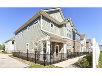 Beautiful two-story home featuring a stylish exterior with a black metal fence, stone accents, and a manicured lawn at 9217 Hawley Dr, Indianapolis, IN 46216