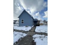 Newly renovated blue house with snow-covered yard at 1256 Kappes St, Indianapolis, IN 46221