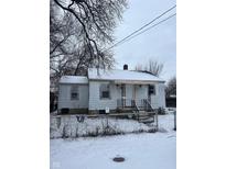 White single story home with a covered front porch and chain link fence at 1300 S Mound St, Muncie, IN 47302
